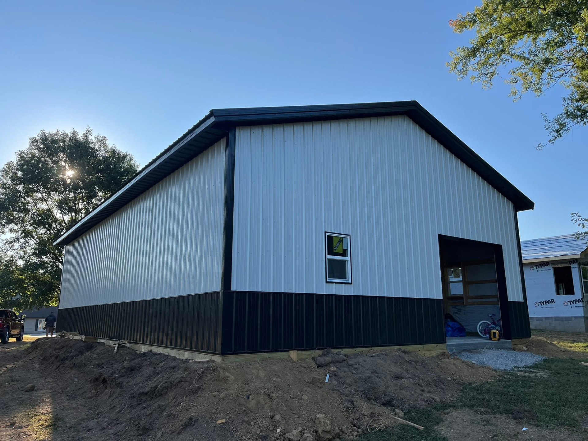 White and black post-frame pole barn